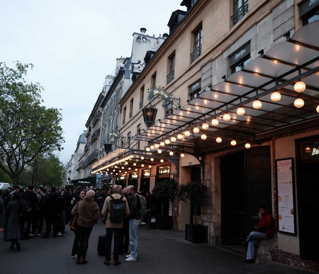 People gathered outside a building with illuminated lights.